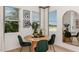 Bright dining area with a round table and green velvet chairs at 8958 Daybreak St, Sarasota, FL 34241