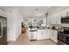 Open concept kitchen with island, stainless steel appliances, and white cabinets at 8958 Daybreak St, Sarasota, FL 34241