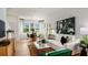 Bright and airy living room with white sofa and emerald green accents at 8958 Daybreak St, Sarasota, FL 34241