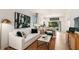 Open living room featuring a white sofa and a view of the kitchen at 8958 Daybreak St, Sarasota, FL 34241