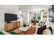 Living room features a white couch, wood media console and dining area at 8958 Daybreak St, Sarasota, FL 34241