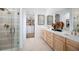 Elegant bathroom with double vanity and walk-in shower at 9985 Key Haven Rd, Seminole, FL 33777
