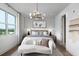 Bright bedroom with a comfy seating area and water views at 9985 Key Haven Rd, Seminole, FL 33777