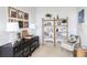 Charming home office with built-in shelving and comfortable seating at 9985 Key Haven Rd, Seminole, FL 33777