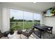 Relaxing screened balcony with outdoor furniture and scenic views at 9985 Key Haven Rd, Seminole, FL 33777