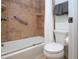 Clean bathroom with shower/tub combo and neutral tile at 1001 Benjamin Franklin Dr # 110, Sarasota, FL 34236