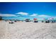 Expansive beach view with colorful umbrellas at 1001 Benjamin Franklin Dr # 110, Sarasota, FL 34236