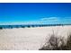 Scenic beach with clear blue water and blue umbrellas at 1001 Benjamin Franklin Dr # 110, Sarasota, FL 34236