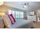 Bedroom with ceiling fan, large windows and dresser at 1001 Benjamin Franklin Dr # 110, Sarasota, FL 34236