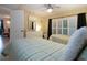 Guest bedroom with twin beds, dresser and shared bathroom at 1001 Benjamin Franklin Dr # 110, Sarasota, FL 34236