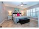 Comfortable bedroom with ceiling fan and coastal decor at 1001 Benjamin Franklin Dr # 110, Sarasota, FL 34236