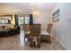 Bright dining room with glass table and wicker chairs at 1001 Benjamin Franklin Dr # 110, Sarasota, FL 34236