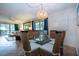 Dining area with glass top table and wicker chairs at 1001 Benjamin Franklin Dr # 110, Sarasota, FL 34236