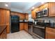 Modern kitchen with stainless steel appliances and wood cabinets at 1001 Benjamin Franklin Dr # 110, Sarasota, FL 34236