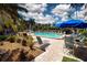 Inviting pool area with lounge chairs and umbrellas at 1001 Benjamin Franklin Dr # 110, Sarasota, FL 34236