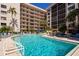 Large resort-style pool with plenty of lounge chairs at 1001 Benjamin Franklin Dr # 110, Sarasota, FL 34236