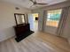 Bright bedroom with large window and light wood floors at 1010 Villagio Cir # 207, Sarasota, FL 34237