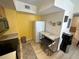 Kitchen area with white refrigerator and marble-top breakfast bar at 1010 Villagio Cir # 207, Sarasota, FL 34237