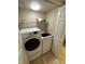 Convenient laundry room with washer and dryer, and overhead shelving at 1010 Villagio Cir # 207, Sarasota, FL 34237