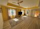 Bright living room with light wood floors, neutral walls, and a ceiling fan at 1010 Villagio Cir # 207, Sarasota, FL 34237