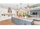 Modern kitchen with gray island and white cabinetry at 10157 Silent Night Ln, Sarasota, FL 34241