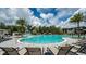 Resort-style pool with a waterslide and plenty of lounge chairs at 10157 Silent Night Ln, Sarasota, FL 34241