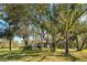 House surrounded by lush trees and green grass at 11701 Marsh Head Road, Sarasota, FL 34240