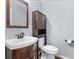 Small half bathroom with a pedestal sink and toilet at 11701 Marsh Head Road, Sarasota, FL 34240