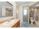 Bathroom with shower, bathtub, and updated vanity at 11701 Marsh Head Road, Sarasota, FL 34240