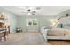 Bright bedroom with tile floors, a ceiling fan, and a view of the backyard at 11701 Marsh Head Road, Sarasota, FL 34240