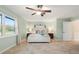 Serene bedroom with a queen bed, soft color palette, and a large window at 11701 Marsh Head Road, Sarasota, FL 34240