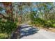 Long driveway leading to home, tree-lined and paved at 11701 Marsh Head Road, Sarasota, FL 34240