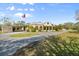 Spanish style home with circular driveway and landscaping at 11701 Marsh Head Road, Sarasota, FL 34240