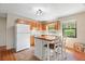 Well-equipped kitchen with wood cabinets, a center island, and tile flooring at 11701 Marsh Head Road, Sarasota, FL 34240