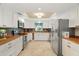 Modern kitchen with white cabinets, butcher block counters, and stainless steel appliances at 11701 Marsh Head Road, Sarasota, FL 34240