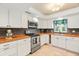 Updated kitchen, featuring butcher block countertops and stainless steel appliances at 11701 Marsh Head Road, Sarasota, FL 34240