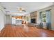 Open living space featuring wood floors, a stone fireplace, and kitchen island at 11701 Marsh Head Road, Sarasota, FL 34240