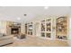 Living room with stone fireplace and built-in shelving at 11701 Marsh Head Road, Sarasota, FL 34240