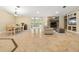 Open living and dining area with stone fireplace at 11701 Marsh Head Road, Sarasota, FL 34240