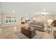 Open living room showcasing a large window, tile floors and adjacent kitchen at 11701 Marsh Head Road, Sarasota, FL 34240