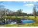 Serene pond view with a canoe and lush greenery at 11701 Marsh Head Road, Sarasota, FL 34240