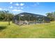 Screened pool and patio area with outdoor furniture at 11701 Marsh Head Road, Sarasota, FL 34240