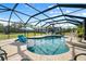 Relaxing pool and patio area with screened enclosure offering shade and privacy at 11701 Marsh Head Road, Sarasota, FL 34240