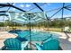 Inviting pool area with covered patio, lounge chairs, and tranquil water feature at 11701 Marsh Head Road, Sarasota, FL 34240