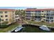 Aerial view of waterfront condo building with boat slips and lush landscaping at 1215 S Portofino Dr # 108, Sarasota, FL 34242