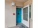 Bright teal front door with starfish decor, welcoming entryway at 1215 S Portofino Dr # 108, Sarasota, FL 34242