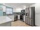 Modern kitchen with stainless steel appliances and white cabinets at 1215 S Portofino Dr # 108, Sarasota, FL 34242