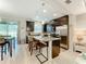 Modern kitchen with dark cabinetry, granite countertops, and an island at 12455 Trailhead Dr, Bradenton, FL 34211