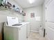 Laundry room with washer, dryer, and overhead shelving at 12455 Trailhead Dr, Bradenton, FL 34211