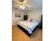 Bright bedroom with king-size bed, wood floors, and ceiling fan at 1318 56Th W St # 1318, Bradenton, FL 34209